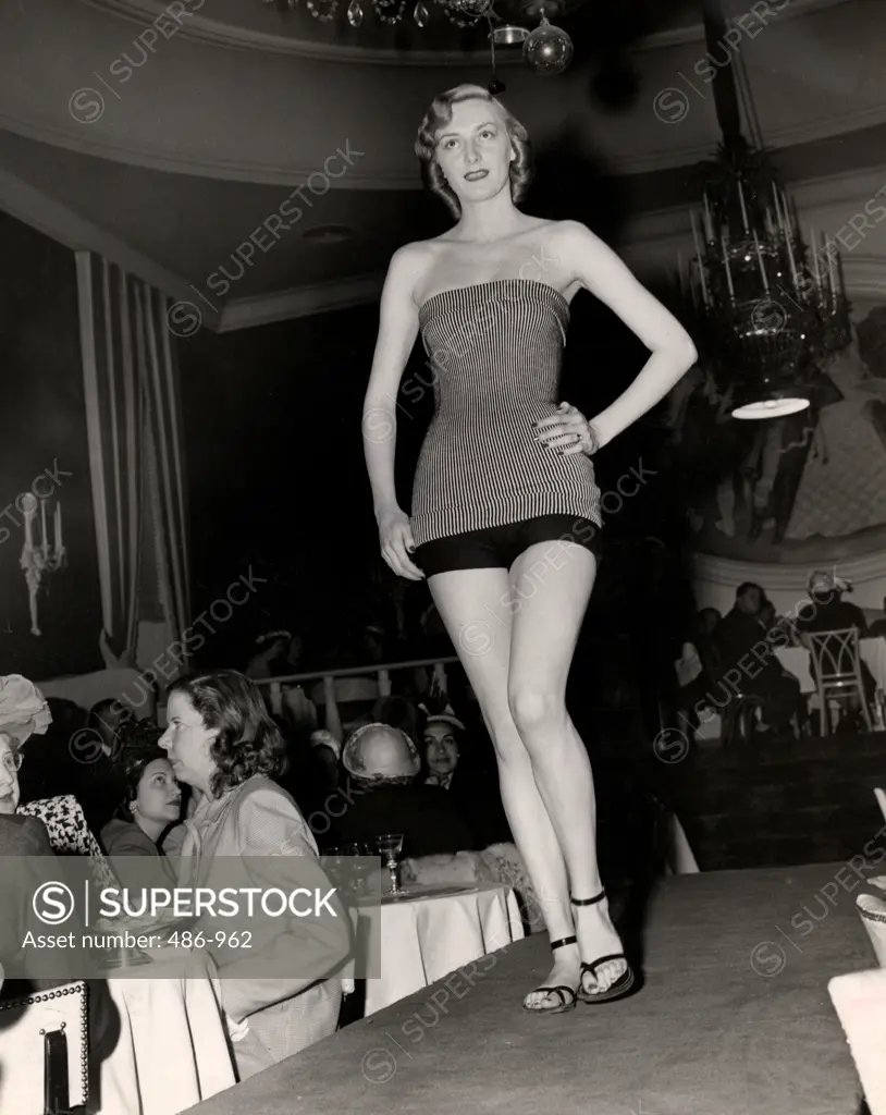 Young woman in swimwear on catwalk