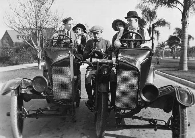 Two mid adult couples getting a speeding ticket