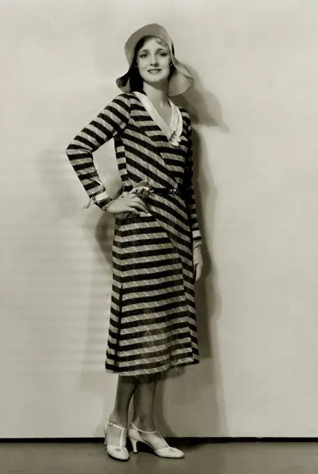 Young woman in striped dress and sun hat, 1931