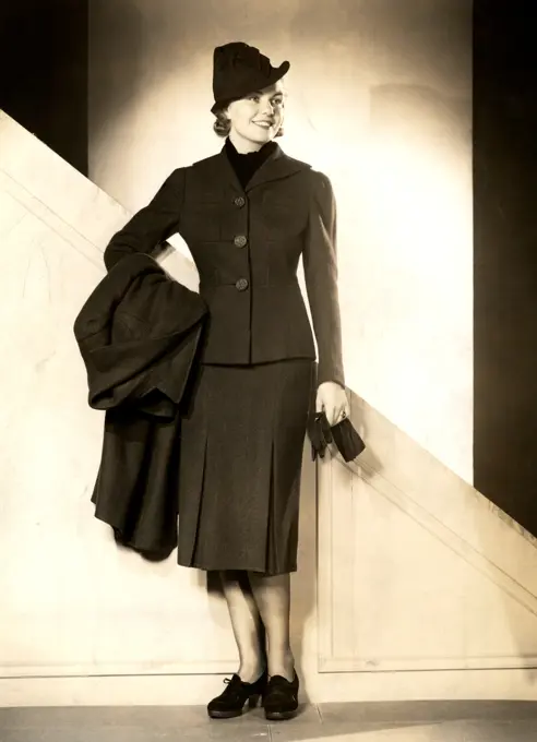 Fashion model posing in winter clothes, studio shot