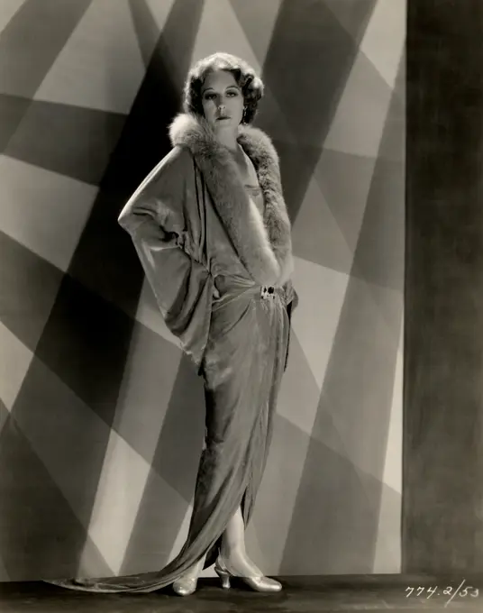 Young woman posing in fur collar dress