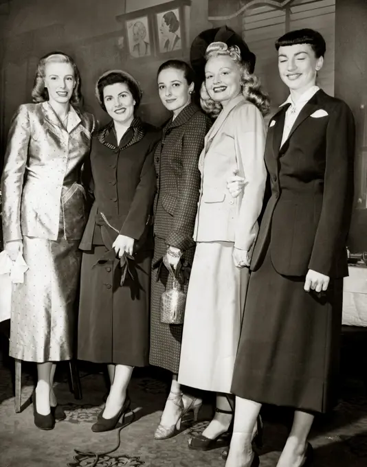 Group of fashion model posing in elegant clothing