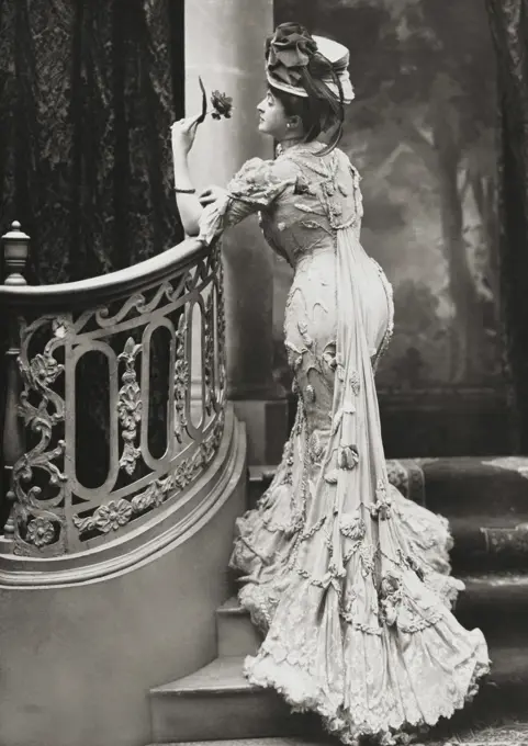 Rear view of a young woman holding a flower