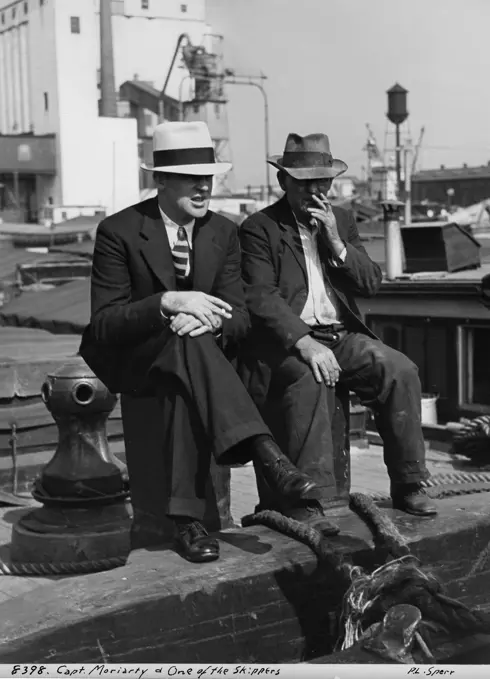 USA, New York City, Two Men Sitting In Harbor