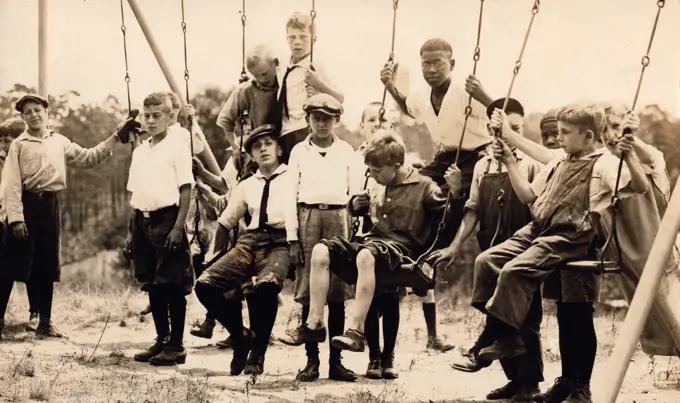 Group of boys playing on swings