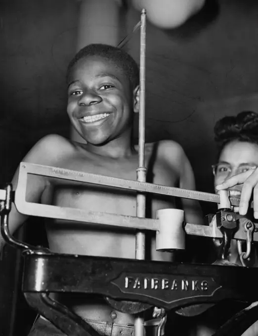 Portrait of boy on weight scale