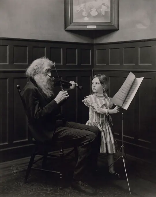 Portrait of man playing violin and girl standing next to him