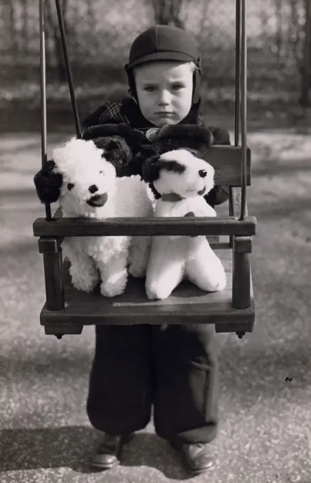 Portrait of boy with stuffed toys on swing