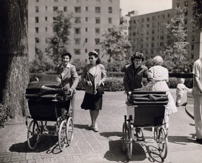 Women pushing baby carriages