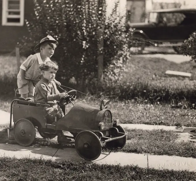 Two boys playing with toy car