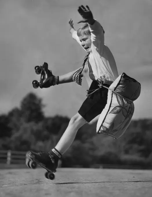 Portrait of boy falling down on roller skates