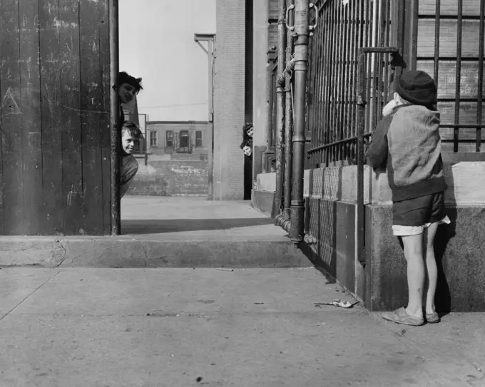 Children peeking around buildings