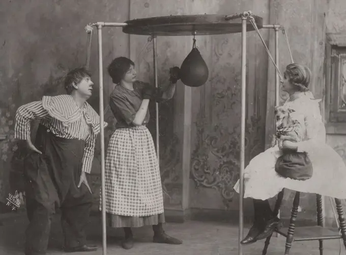 Woman practicing boxing with punching bag