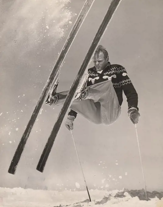 USA, Idaho, Sun Valley, Ski cartoonist Warren Miller executes difficult jump on Baldy Mountain ski trail