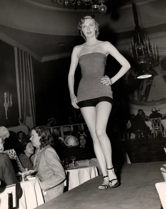 Young woman in swimwear on catwalk