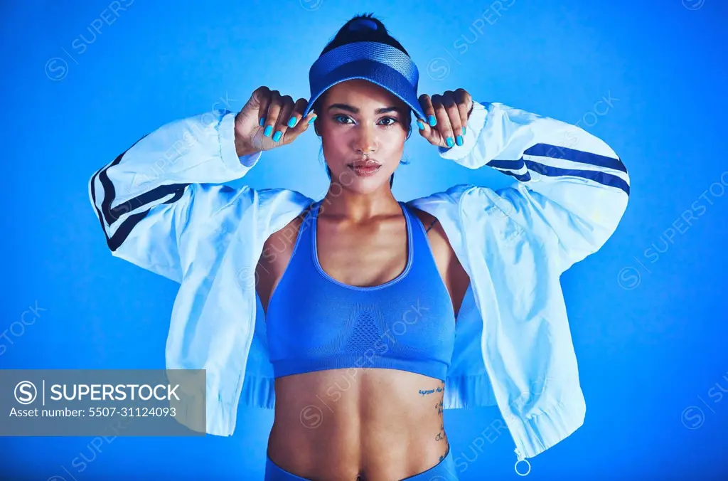 I'm dressed to give my best. Cropped portrait of an attractive young female athlete posing against a blue background.