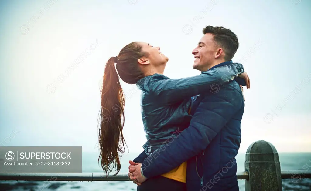 Nothing feels better than love. Shot of a happy young couple embracing outdoors.