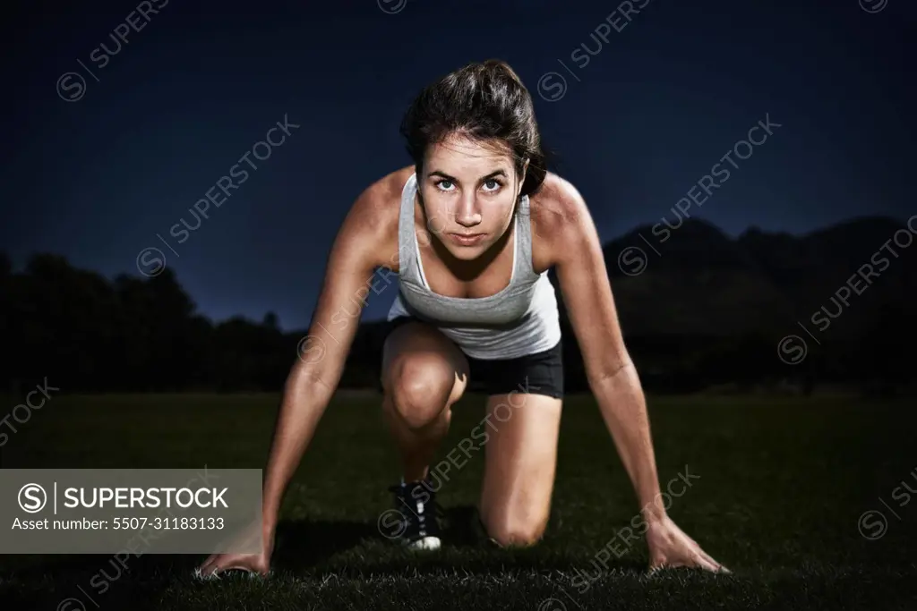 The start to a great race. A young woman at the starting line of a race.