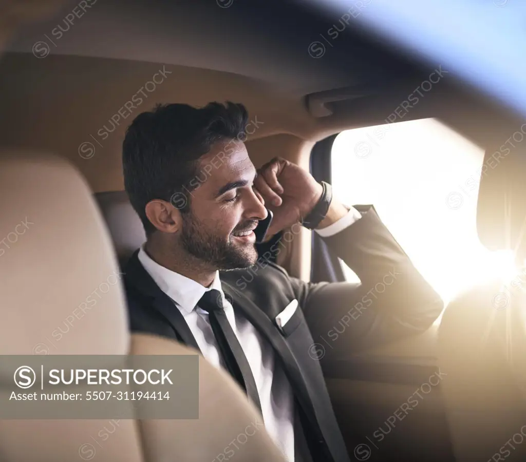 Making the most of his morning commute. Cropped shot of a handsome young businessman making a phonecall while on his morning commute to work.