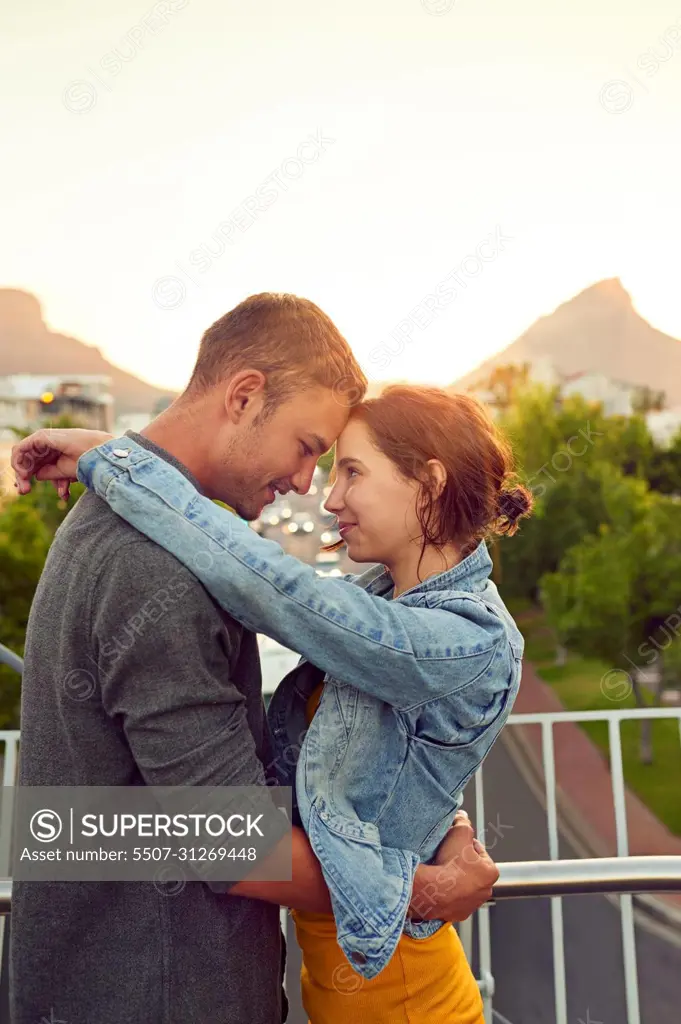 I love falling in love with you. Shot of a happy young couple enjoying a romantic moment in the city.