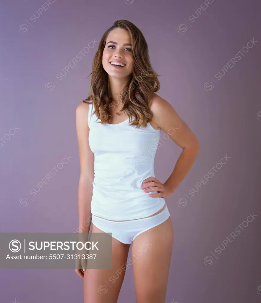 Healthy is the new beautiful. Studio shot of a healthy young woman posing against a purple background.