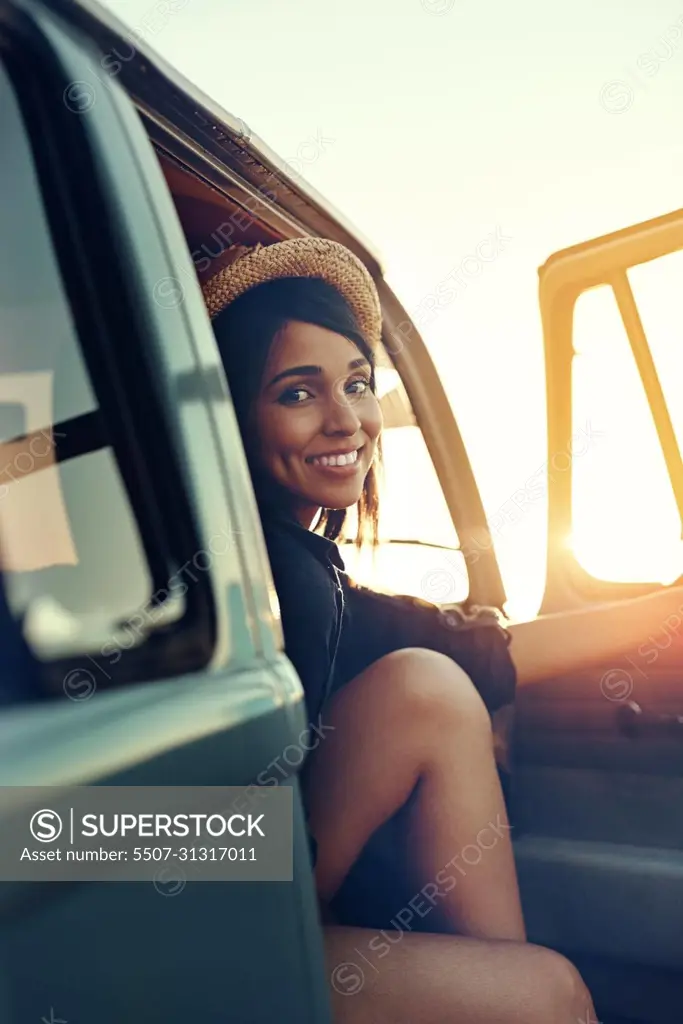 Road tripping it right through summer. Shot of a young woman enjoying a relaxing roadtrip.