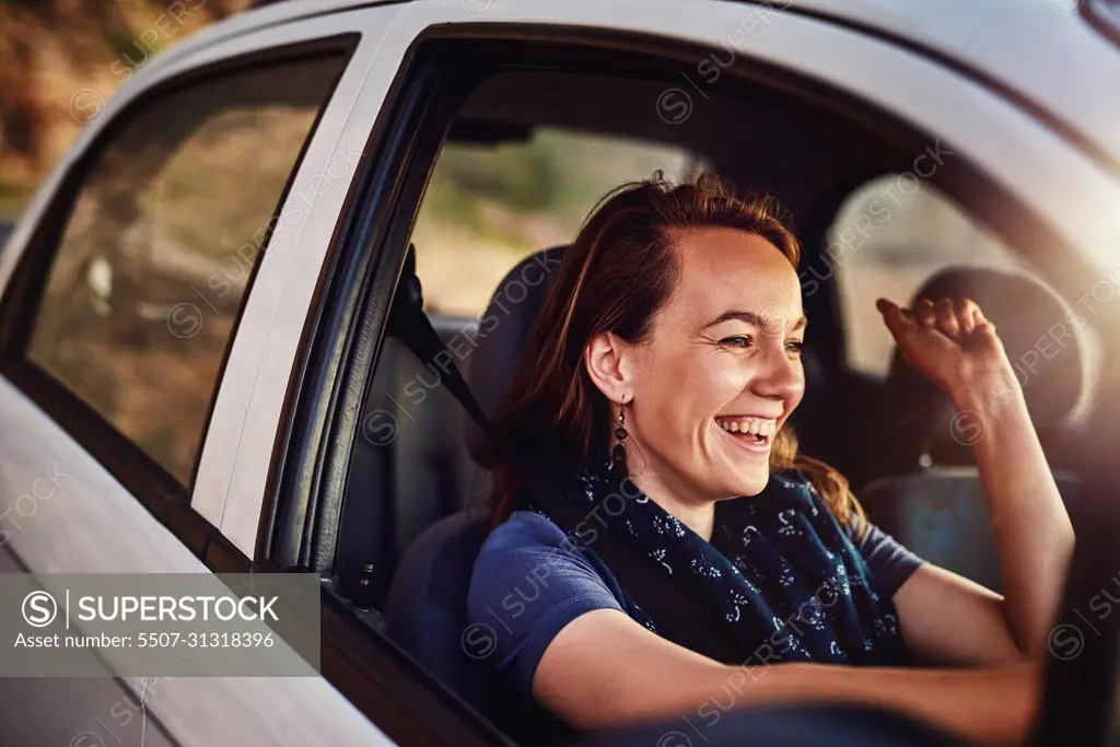 On a solo roadtrip. Cropped shot of a young woman driving in her car.