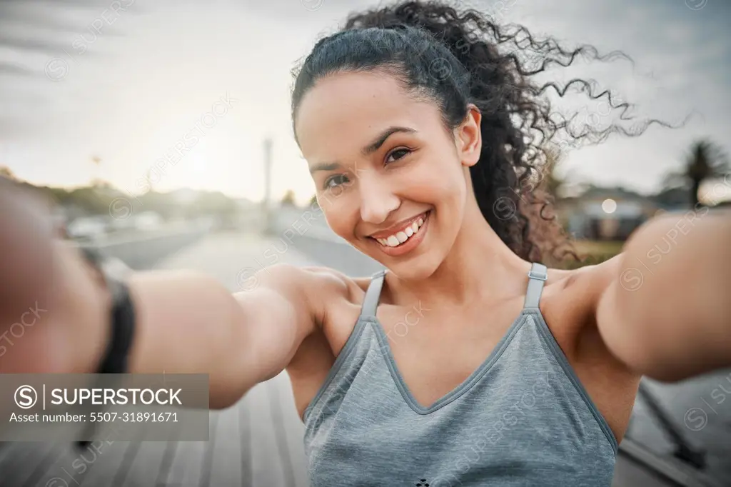 Morning run Complete. Cropped portrait of an attractive young female athlete taking selfies during her morning run outside.