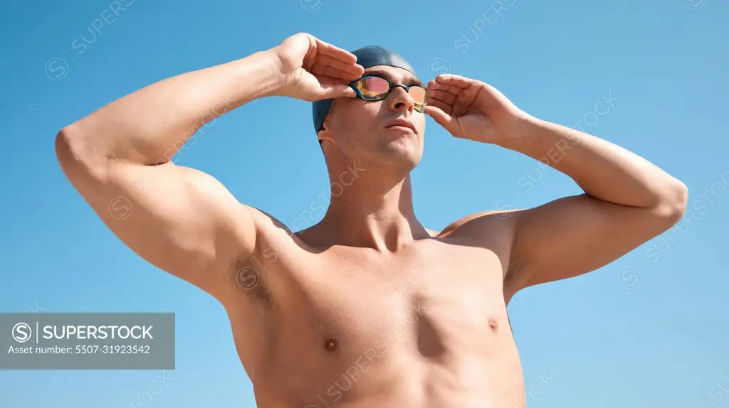 Ready to dive in. a handsome young male athlete swimming in an olympic-sized pool.