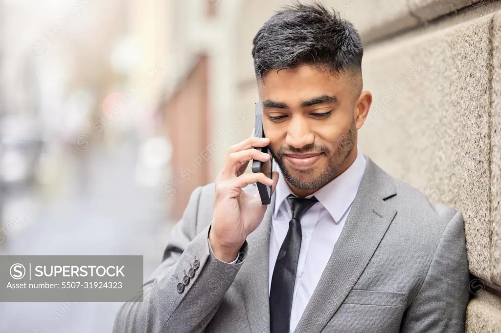 Making big calls in the city. a handsome young businessman traveling through the city on his morning commute into work.