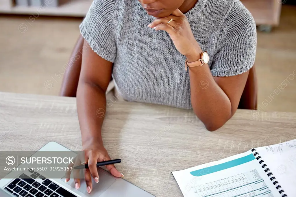 Getting the job done. a businesswoman working on her laptop.