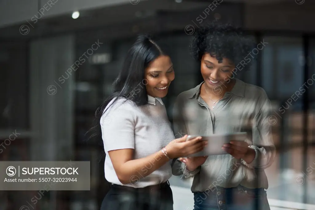 Working overtime to be the best. Two businesswoman working in a modern office.