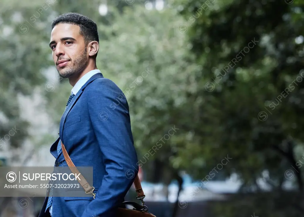 Business savvy. a handsome young businessman on his morning commute into work.