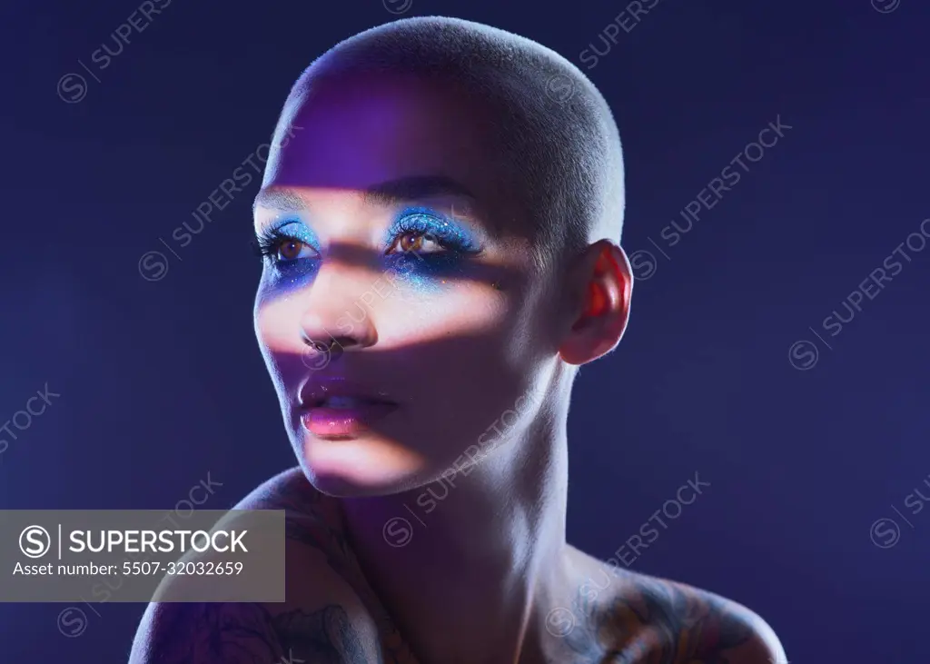 I rather be true to myself than hide my authenticity. Studio shot of an attractive young woman wearing edgy makeup against a blue background.