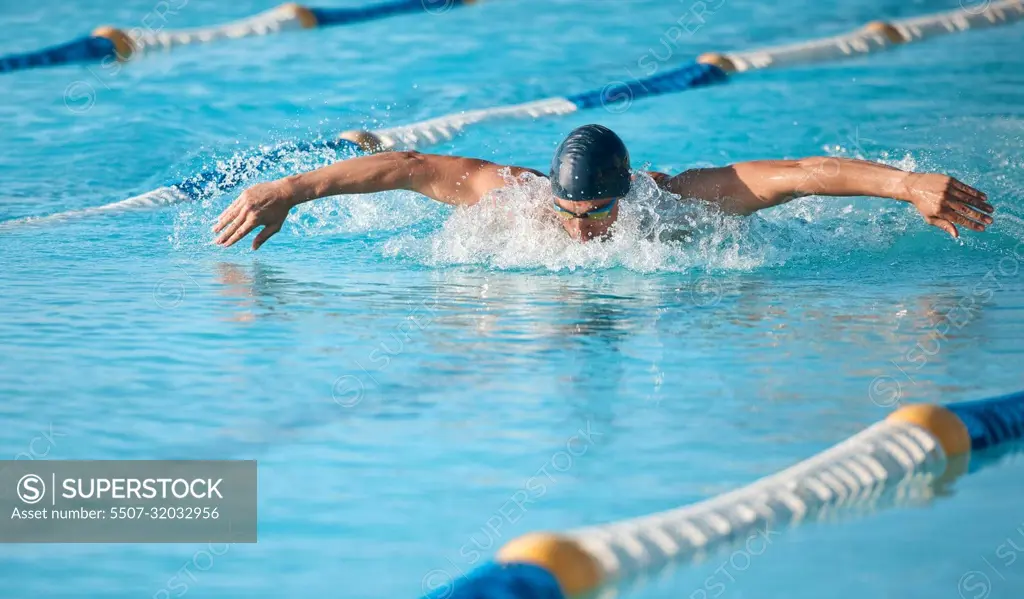 Lap after lap. a handsome young male athlete swimming in an olympic-sized pool.