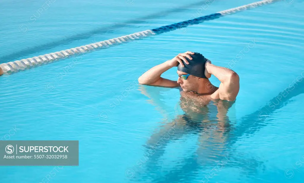 Thinking about the upcoming competition. a handsome young male athlete swimming in an olympic-sized pool.