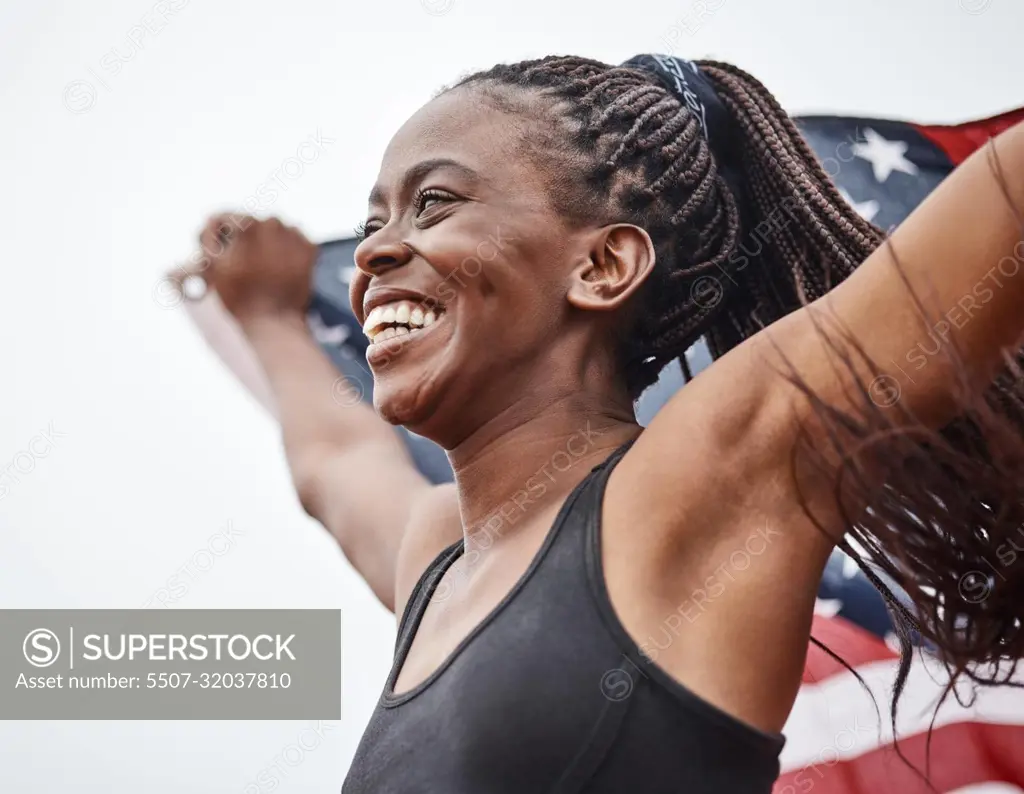 Ive never felt more accomplished. a young female athlete holding a flag.