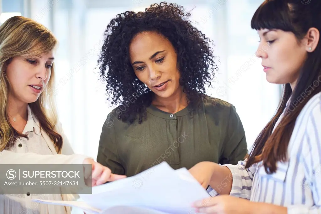 There is always productivity in this office. a group of businesswomen working in the office.