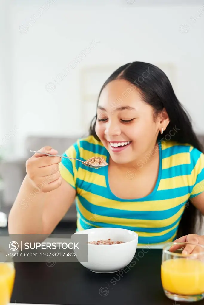 For a healthy start, have a healthy breakfast. a happy young girl enjoying a healthy breakfast at home.