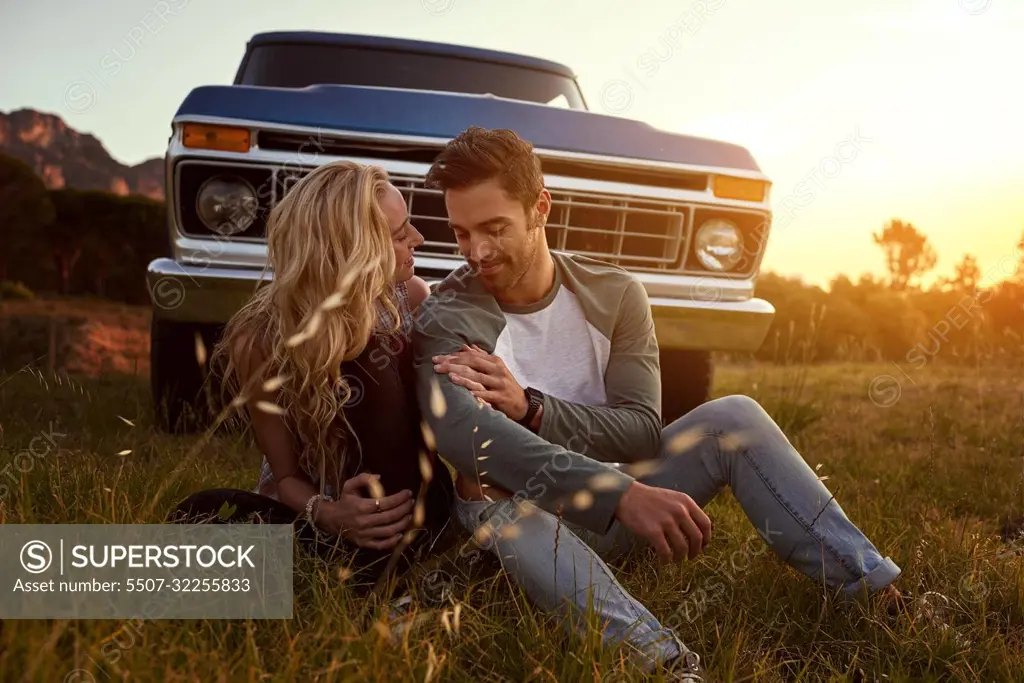 Roadtripping in the name of love. an affectionate young couple on a roadtrip.