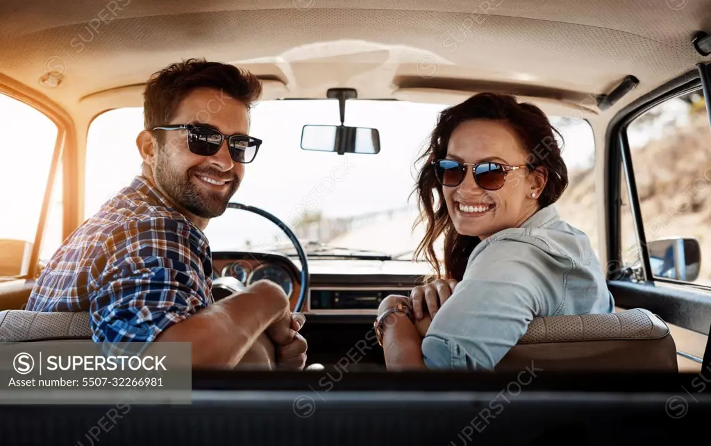 Youll never regret a road trip. Rearview portrait of an affectionate couple enjoying a summer road trip.