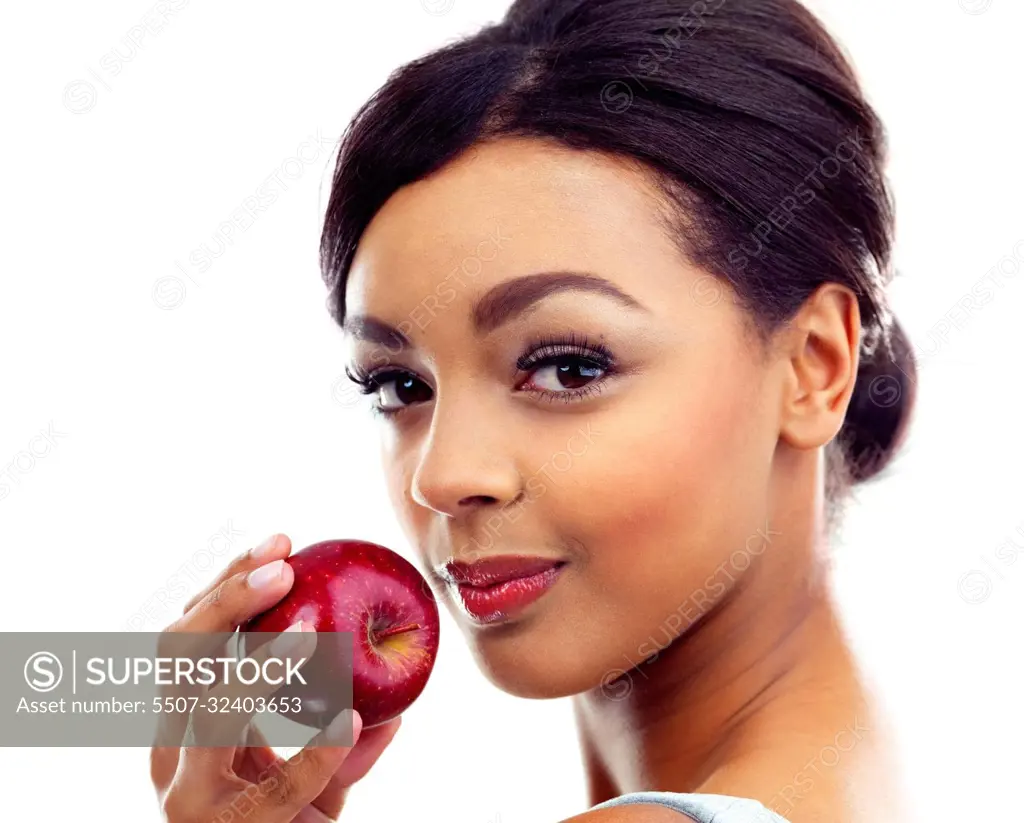 The perfect diet snack. A young woman holding an apple and smiling at the camera.