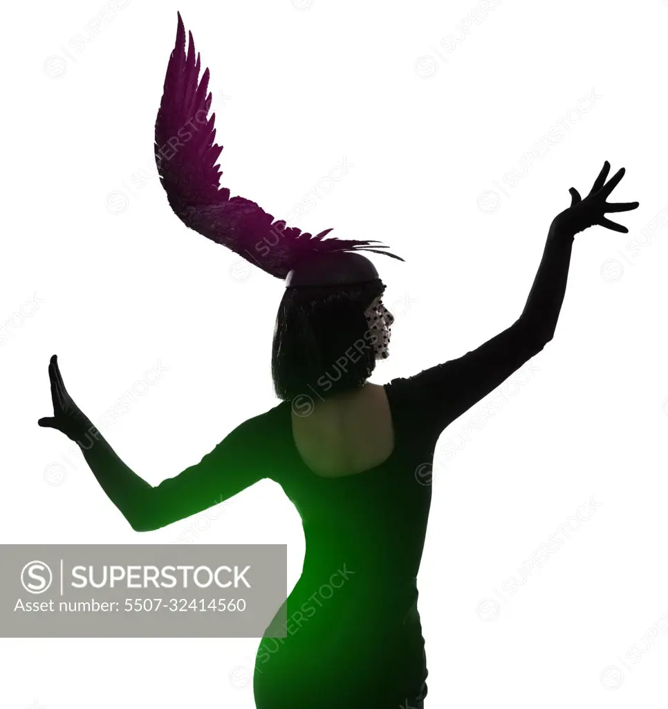 Spreading her fashion wings. Rear view shot of a young woman wearing a wing-shaped headpiece.