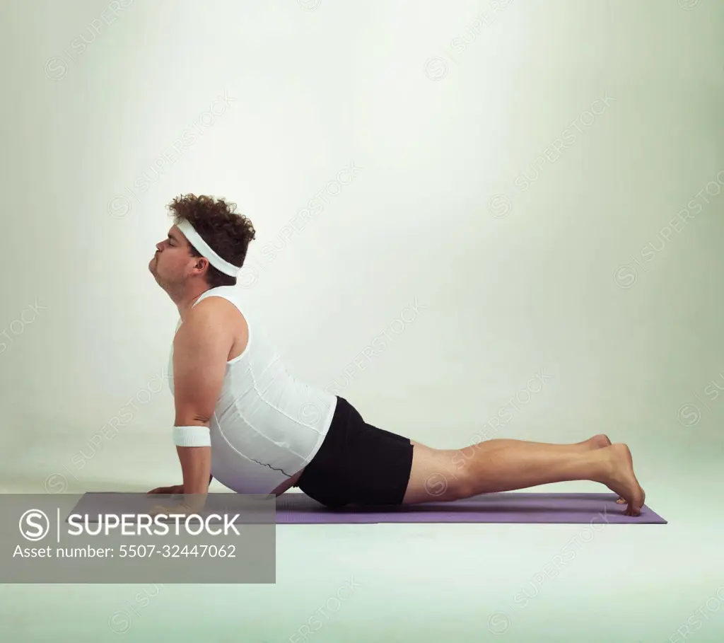 This upward facing dog pose is great. an overweight man doing yoga poses.