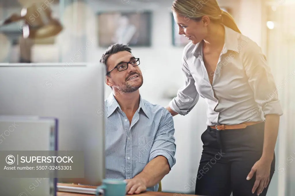 Shes a helpful businesswoman. two colleagues working together on a computer.