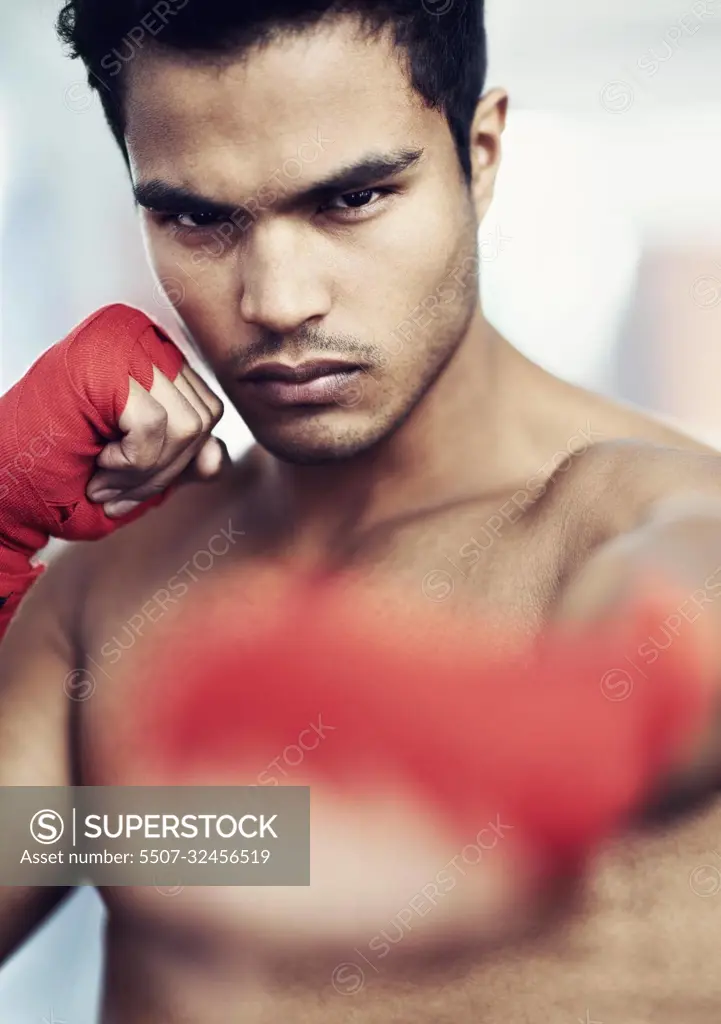 Hes dedicated to the sport of boxing. a young male boxer training.