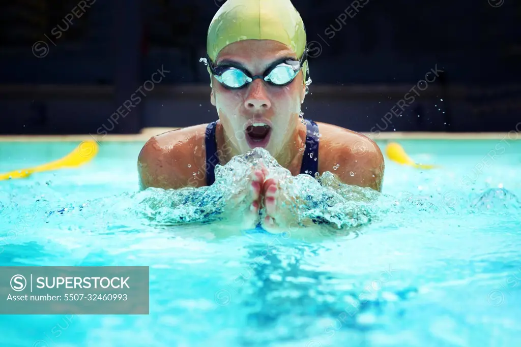 Born to swim. a young female swimmer training by the pools.