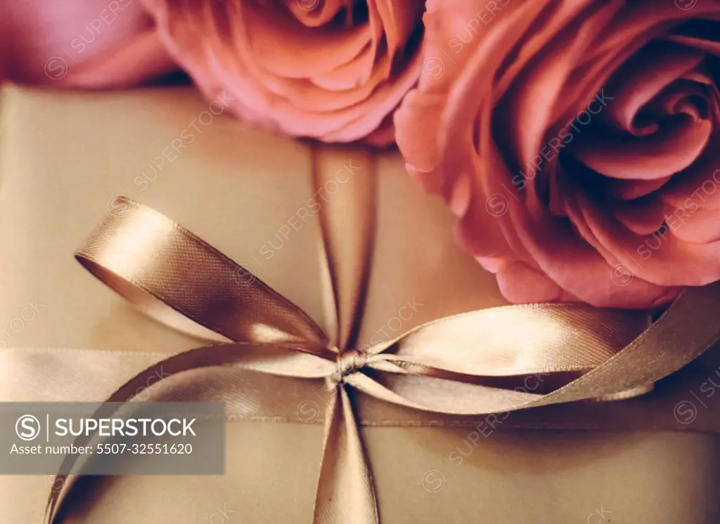 Luxury holiday golden gift box and bouquet of roses as Christmas, Valentines Day or birthday present