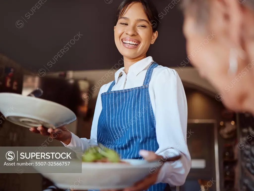 Waitress in a restaurant, serving customer her food, healthy salad and gives service with a smile. Woman in the hospitality industry, friendly laugh and happy to provide diet meal for lunch or dinner