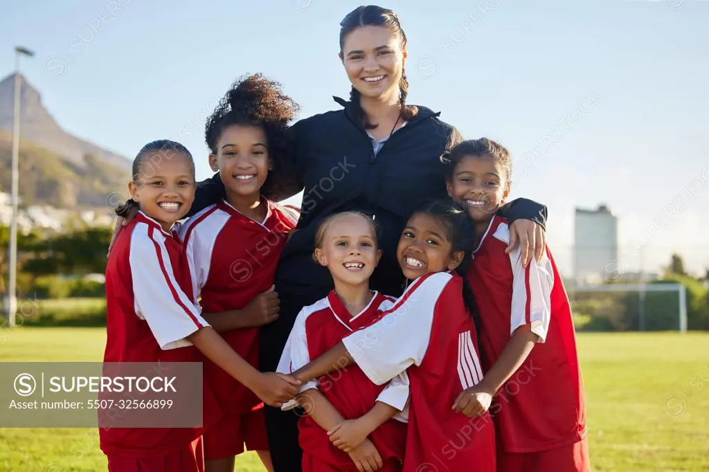 Football, happy and girl team with coach on a sport soccer field after training or a game. Teamwork and collaboration with a happy group of female athletes play for fun, to win and succeed